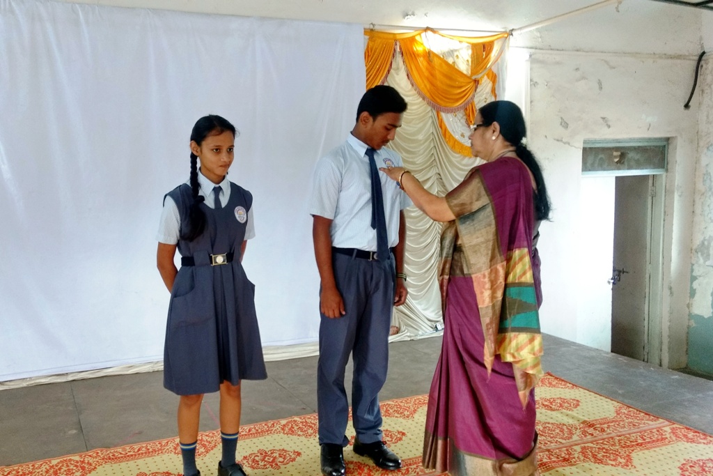 Investiture Ceremony : Principal Mrs. C. S. Rai giving the Badge to the School Vice Captains